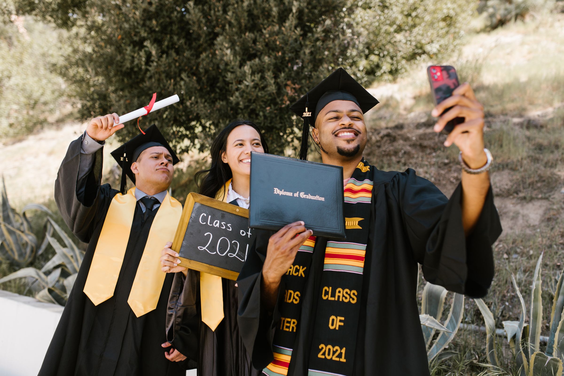 Graduates celebrating together outdoors