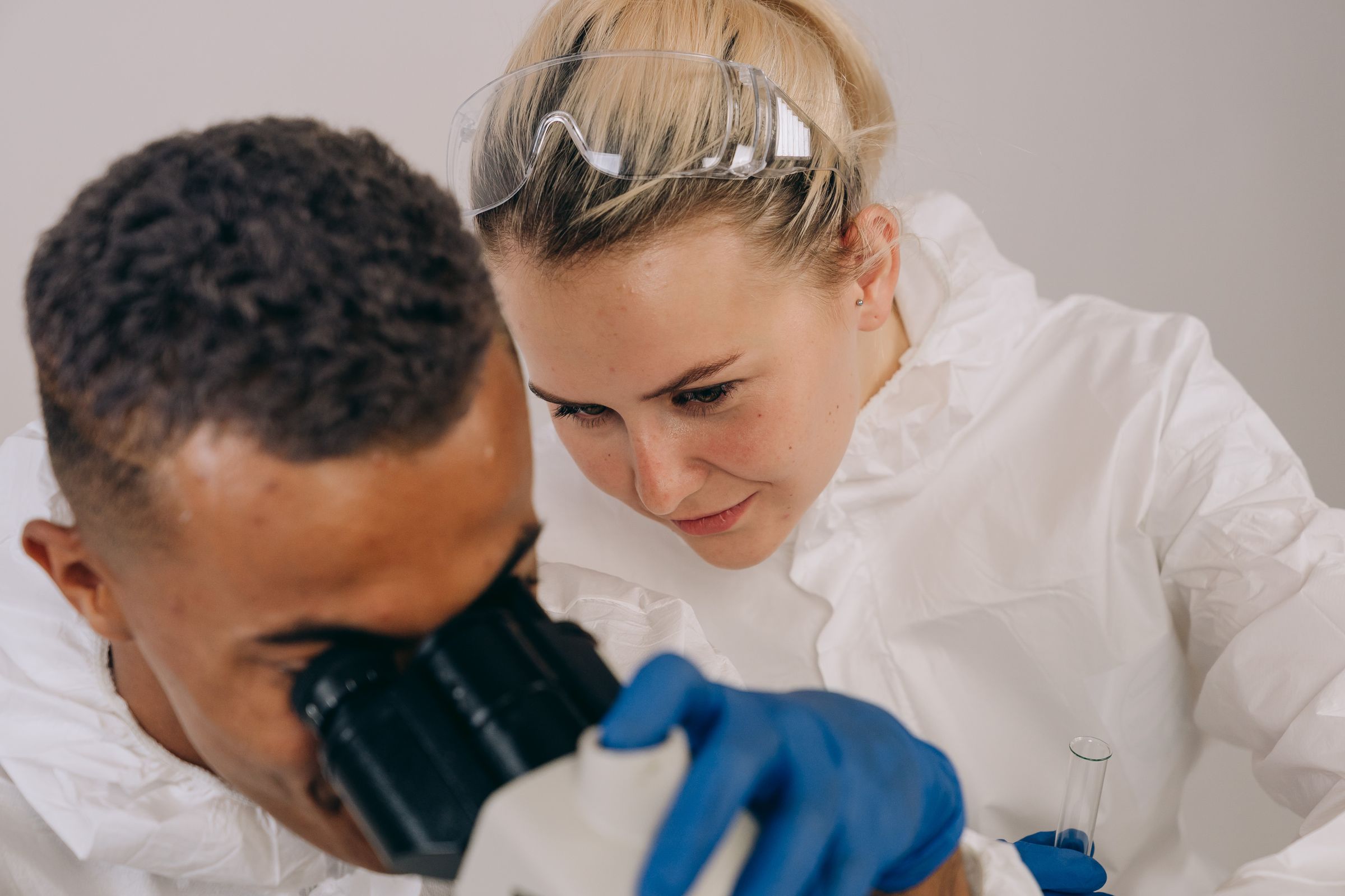 Two researchers at a microscope