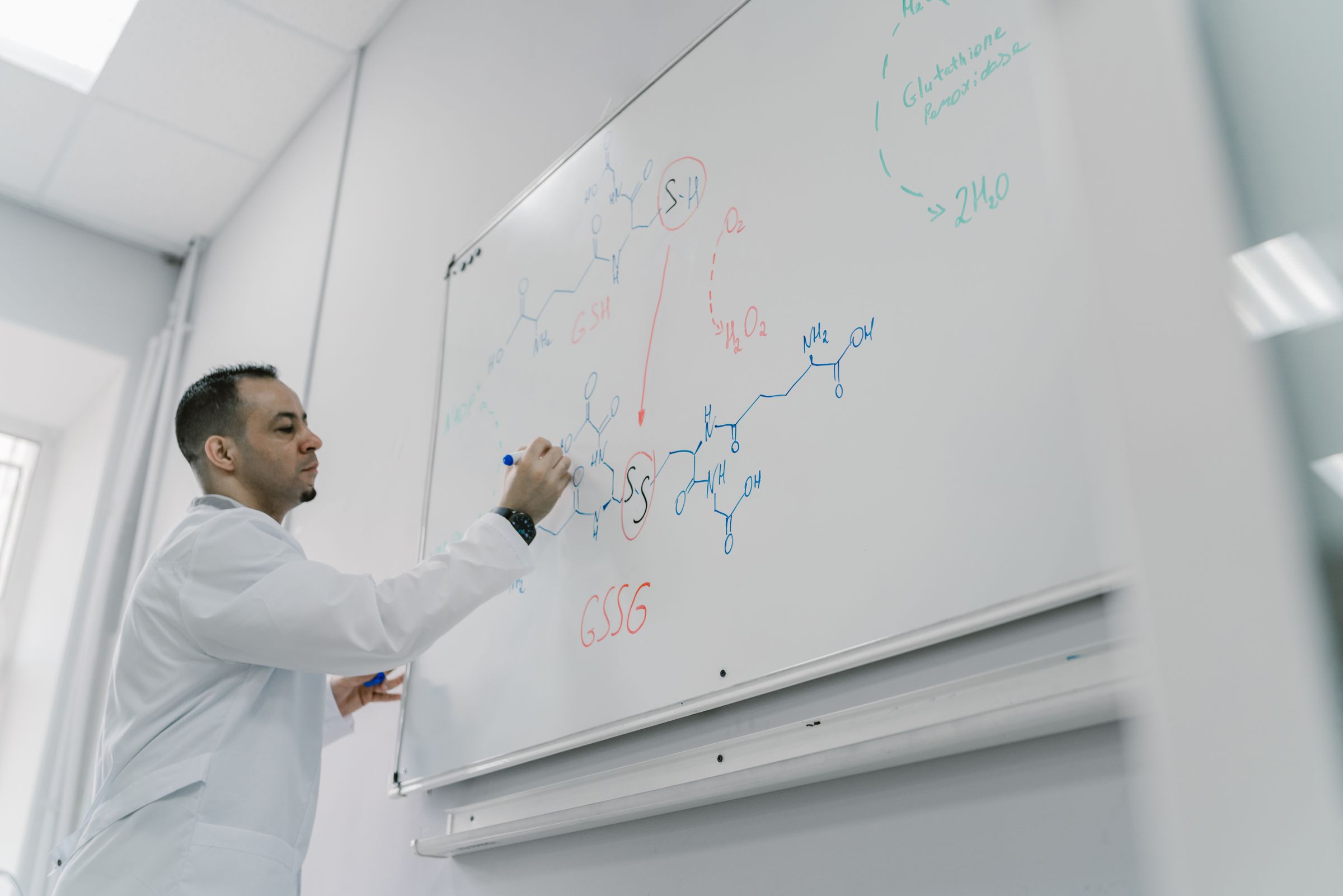 A scientist working at a whiteboard